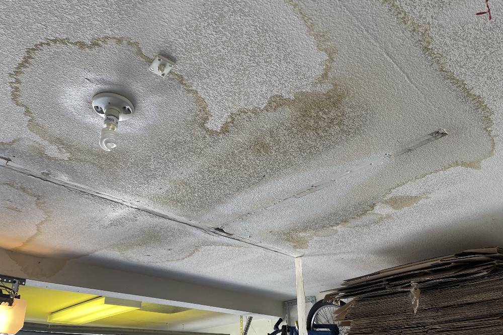 Ceiling with extensive water damage requiring 24/7 emergency plumbing service for repair.